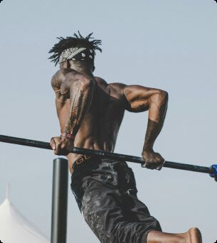 Strong man doing workout on pull-up bar